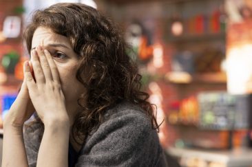 Stock trader devastated about a stock exchange scam and losing money, feeling depressed and worried about her bankruptcy. Sad upset woman looking at market trends go downward on pc.